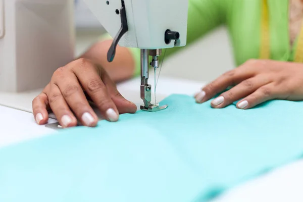 Tailoring Process - Womens hands behind her sewing machine tailor