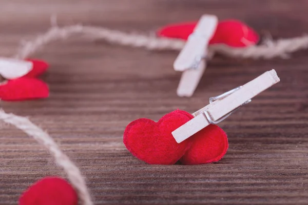 Two red textile hearts connected by clothespin. Love concept. — Stock Photo, Image