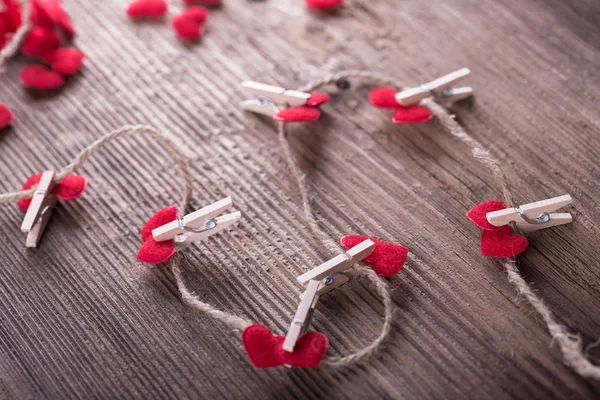 Corações têxteis vermelhos ligados por espinha de roupa. Conceito de amor . — Fotografia de Stock