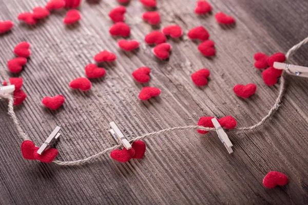 Red textile hearts connected by clothespin. Love concept — Stock Photo, Image