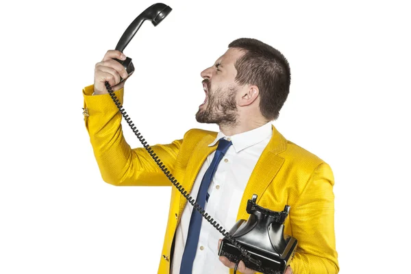 Angry businessman screaming to the telephone handset — Stockfoto