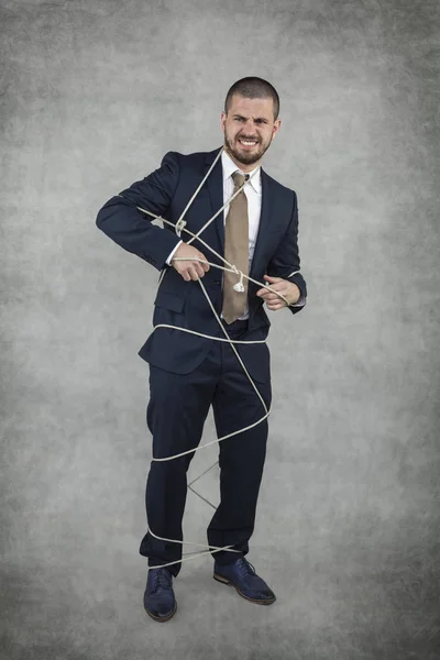 Businessman trying to release — Stock Photo, Image