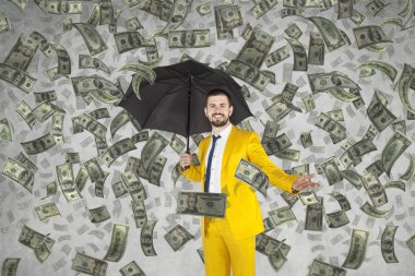 Young rich businessman standing in money rain clipart