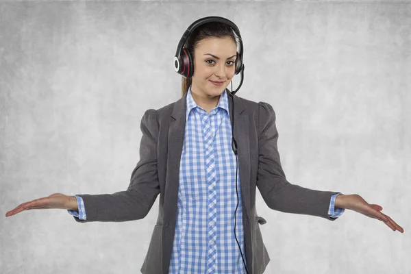 Beautiful woman spreads her hands, earphones on her ears — Stock Photo, Image