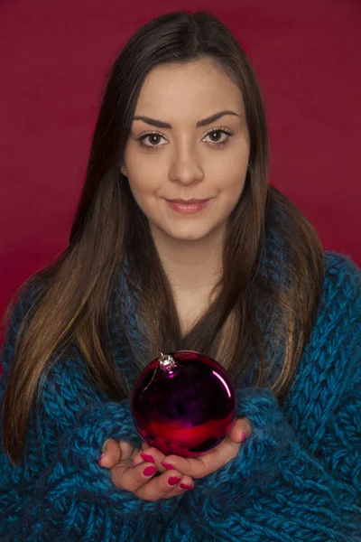 Beautiful girl is holding a christmas bubble in her hand — Stock Photo, Image
