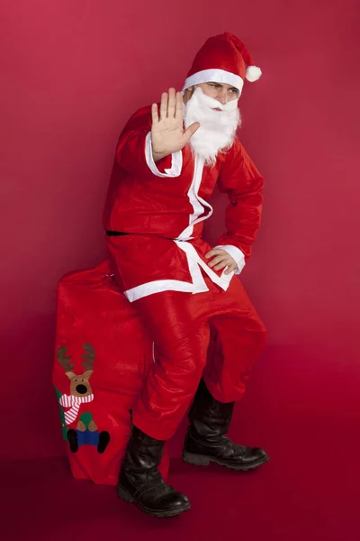 Zmęczony Mikołaj siedzi na worek faszerowane prezenty — Zdjęcie stockowe