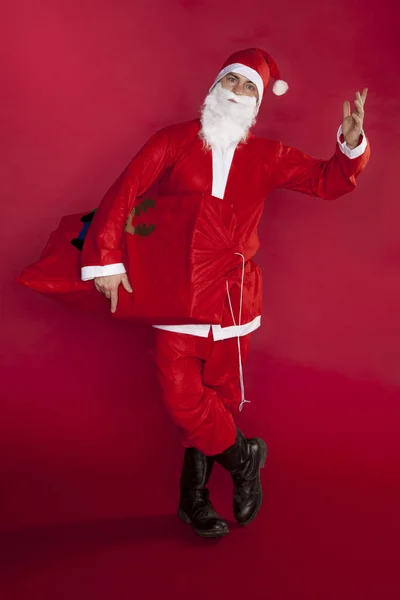 Santa Claus sostiene una bolsa de regalo a mano — Foto de Stock