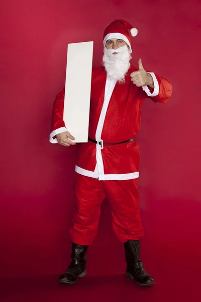 Happy santa clausule houdt een plek voor reclame, duim omhoog — Stockfoto