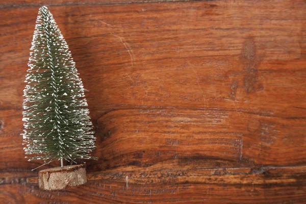 Christmas tree on a wooden background, close up — Stock Photo, Image