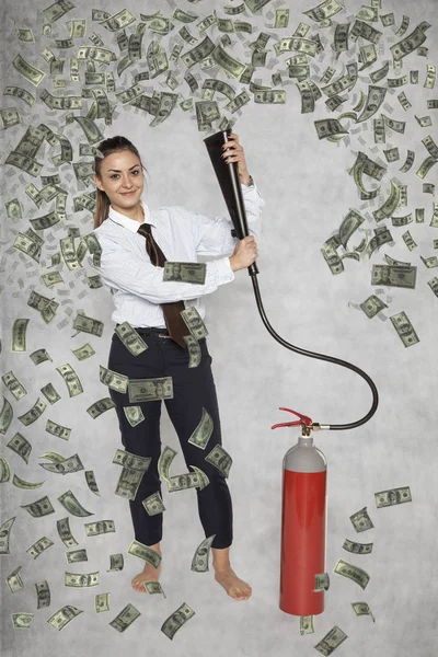businesswoman under a rain of money from a fire extinguisher