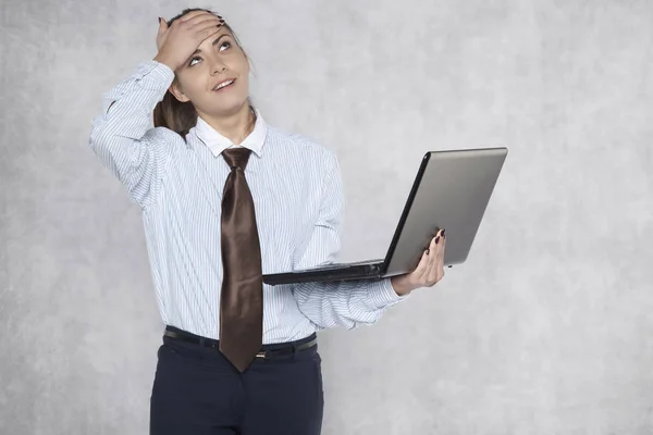 Ung affärskvinna ser i misstro på en laptop skärm — Stockfoto