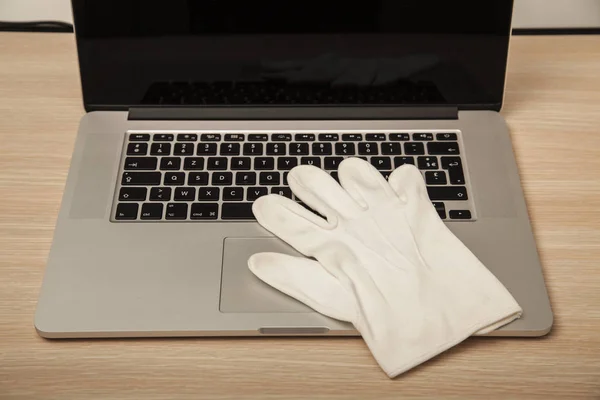 Conceptual photo, the glove on the keyboard shows the possibilit