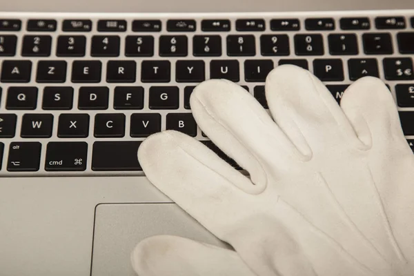 Conceptual photo, the glove on the keyboard shows the possibilit