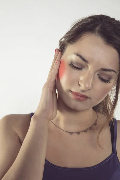 A young woman is struggling with pain, isolated on background — Stock Photo, Image