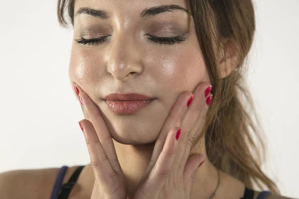 Eine junge Frau kämpft mit Schmerzen, isoliert im Hintergrund — Stockfoto