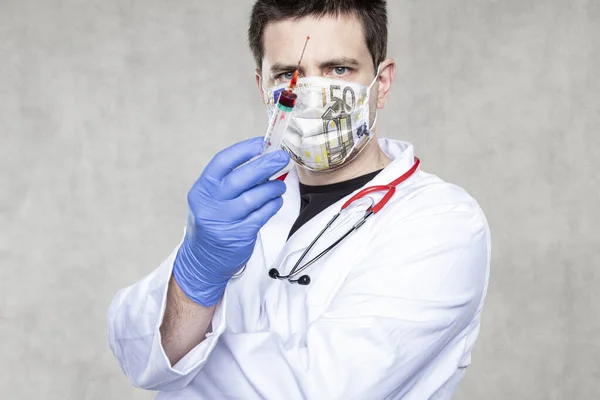 doctor with a vaccine in his hand, a euro mask symbolizing the profit from the sale of vaccinations