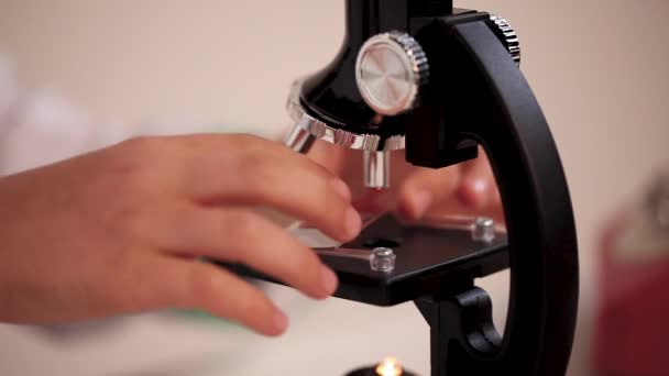 Young Lab Technician Inserts Slide Sample Microscope — Stock Video