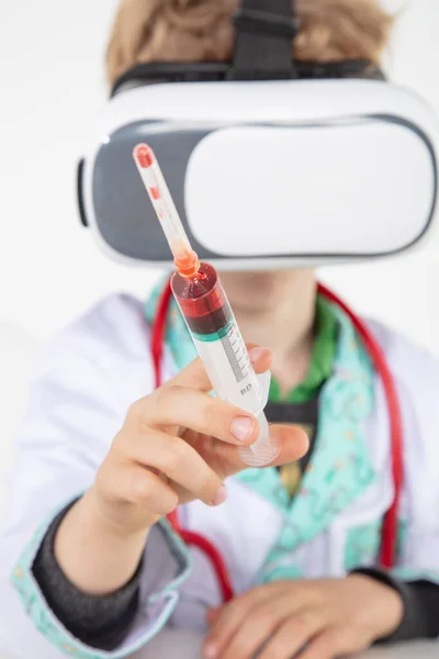 young doctor in virtual reality goggles is working on a 3D model of the vaccine