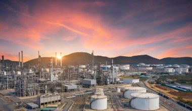 View of Oil and gas industrial refinery zone,Detail of equipment oil pipeline steel and large oil storage tank at twilight