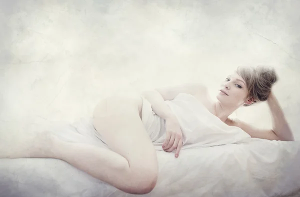 young pretty woman naked in white sheets, textured vintage portrait, art seductive concept