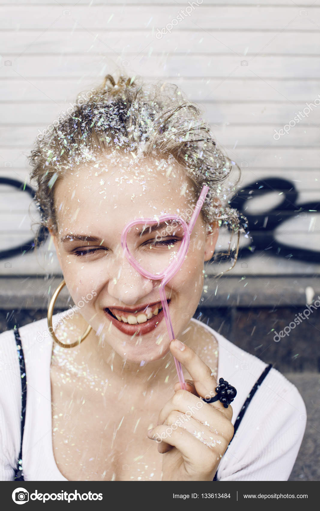Girl smiling covered with glitter tinsel Stock Photo by ©iordani 133613484
