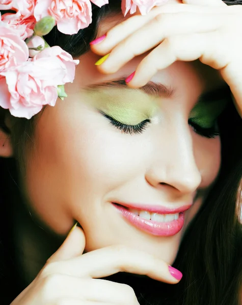 Beauty young real woman with pink flowers and make up closeup