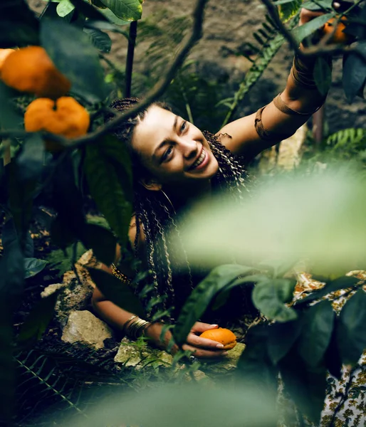 pretty Islam woman in orange grove smiling