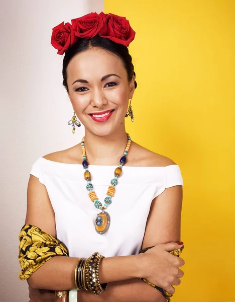 young pretty mexican woman smiling happy on yellow background, l