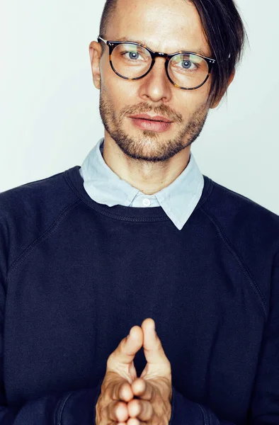young handsome teenage hipster guy posing emotional wearing glasses, happy smiling lifestyle people concept