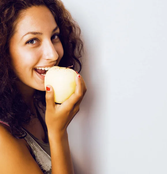 pretty young real tenage girl eating apple close up smiling