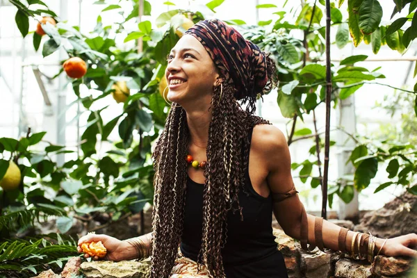 pretty islam woman in orange grove smiling, real muslim girl cheerful , nature organic people concept