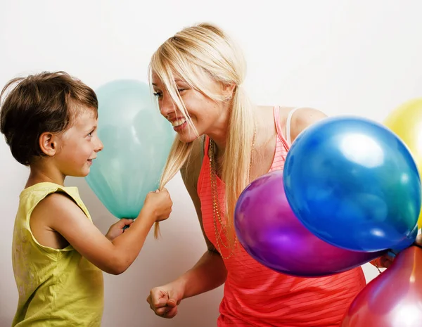 pretty real family with color balloons on white background happy smiling, blonde girl with little boy on holiday, lifestyle people concept