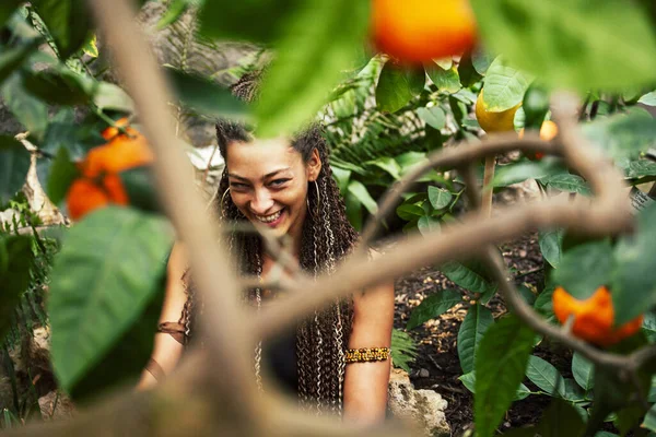 pretty islam woman in orange grove smiling, real muslim girl cheerful , nature organic people concept