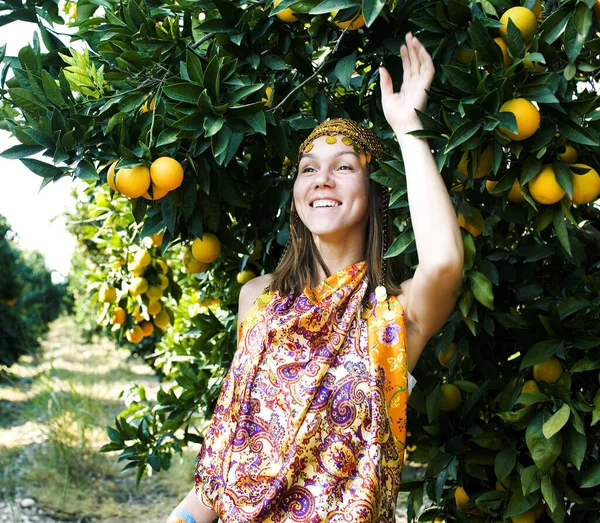 pretty islam woman in orange grove smiling, real muslim girl cheerful close up