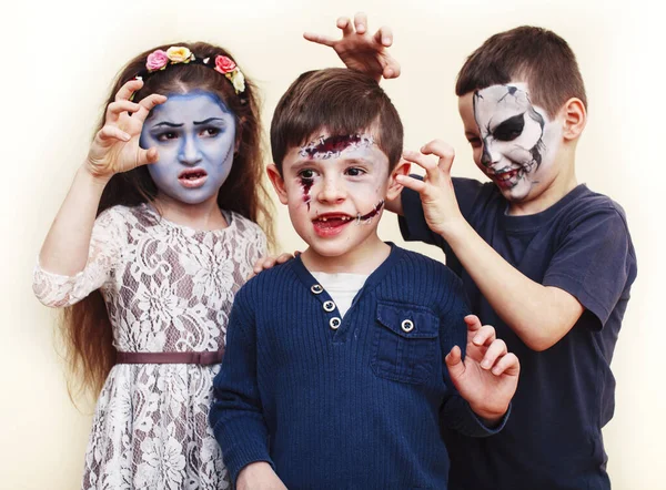 zombie apocalypse kids concept. Birthday party celebration facepaint on children dead bride, scar face, zombie skeleton together closeup makeup emotional posing.