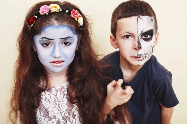 zombie apocalypse kids concept. Birthday party celebration facepaint on children dead bride, scar face, zombie skeleton together closeup makeup emotional posing.