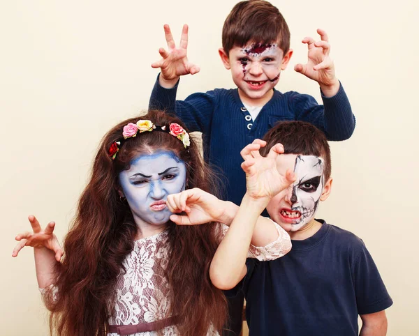 zombie apocalypse kids concept. Birthday party celebration facepaint on children dead bride, scar face, zombie skeleton together closeup makeup emotional posing.