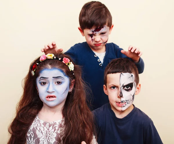 zombie apocalypse kids concept. Birthday party celebration facepaint on children dead bride, scar face, zombie skeleton together closeup makeup emotional posing.