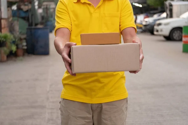 黄色送货员搬运包裹. — 图库照片