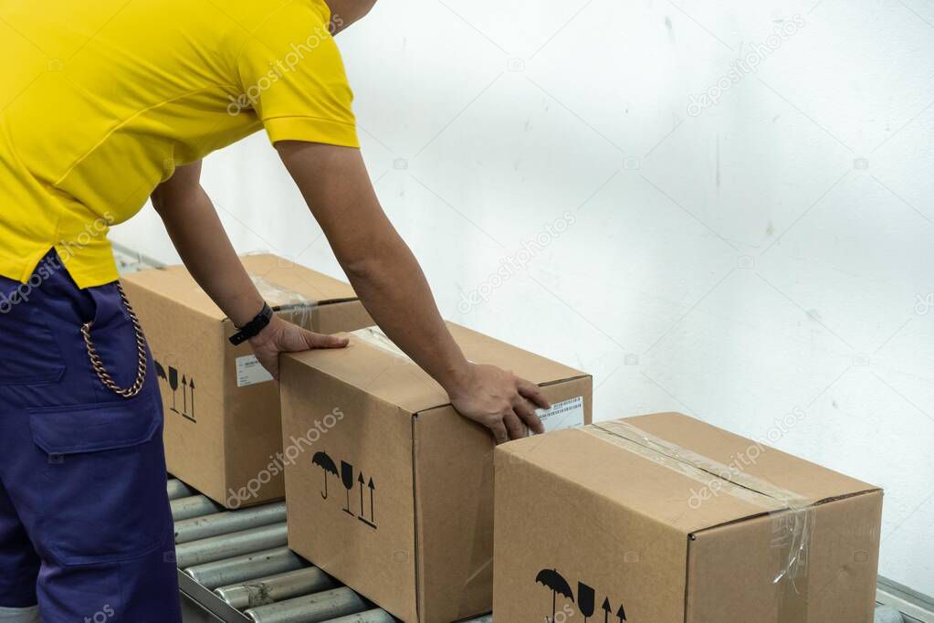 A yellow t-shirt man working in a warehouse.
