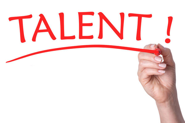 Hand writes word talent with red marker on transparent white background.