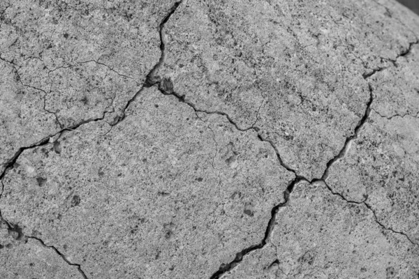 Non-color, monochrome black and white photo. A high resolution old concrete cement with cracks and natural destruction from time and weather conditions.