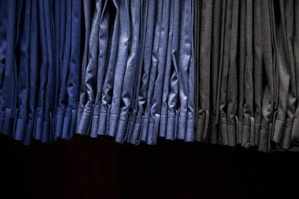 Male pants hanging on a clothes hanger inside a clothing store. — Stock Photo, Image