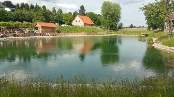 lake at a resort with restaurant at the forest edge