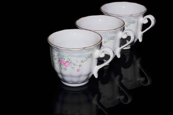 Three Old White Porcelain Cups Stand Row Black Background — Stock Photo, Image