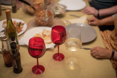 People about to eat and drink at dinner table