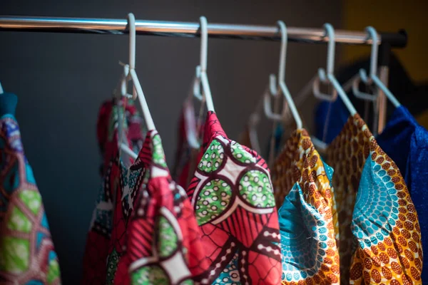 African print clothing hanging on railing