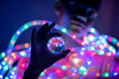 Young boy holding crystal ball in his hand
