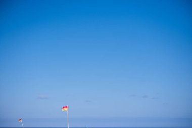 Flags on local beach inducating safe swimming area