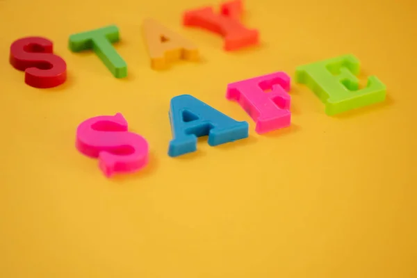 Words spelling stay safe against yellow background — Stock Photo, Image